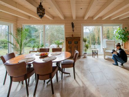 Salle à manger avec carreaux de travertin Rustique et femme prenant des photos du sol en pierre naturelle